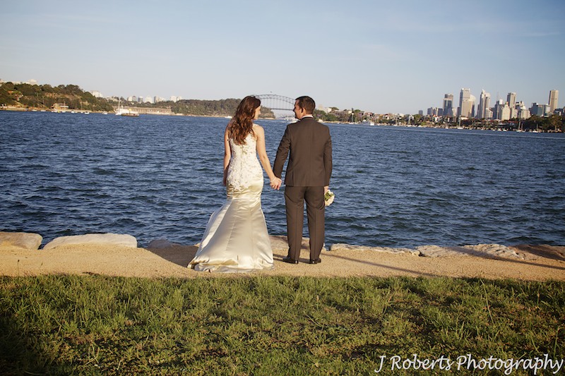 Couple holding hands looking at the harbour from Clarks Point Woolwich - wedding photography sydney